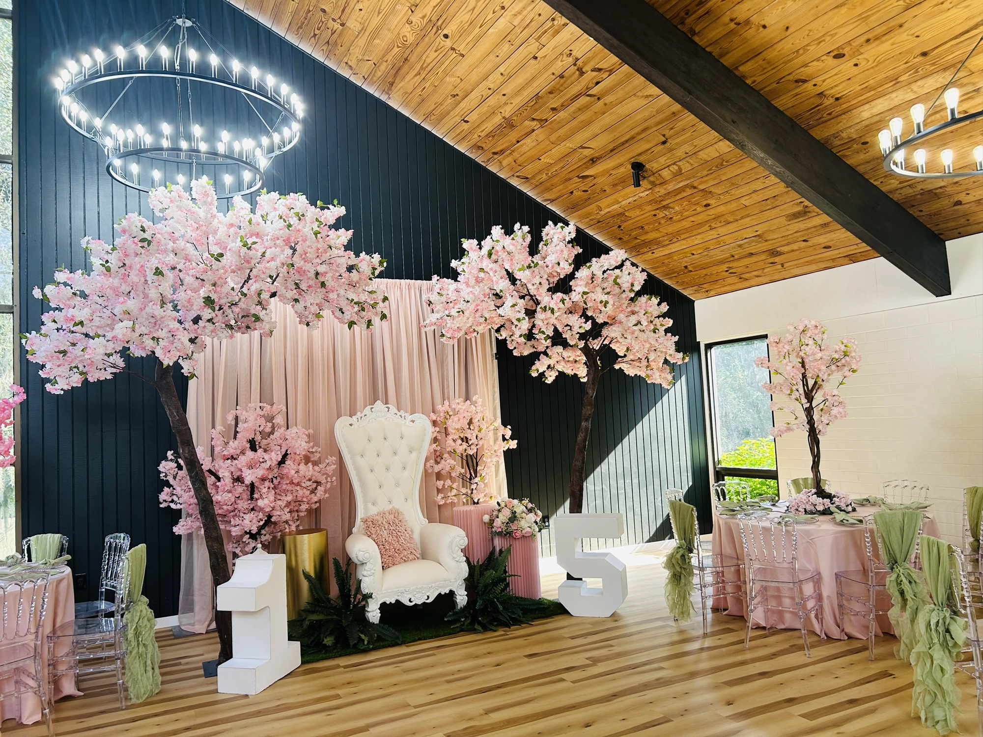 Vibrant quinceañera ceremony backdrop pink green florals